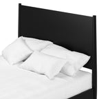 Black headboard with white pillows and bedding on a white background
