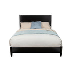 Bed with black frame, beige bedding, and blue blanket on a white background