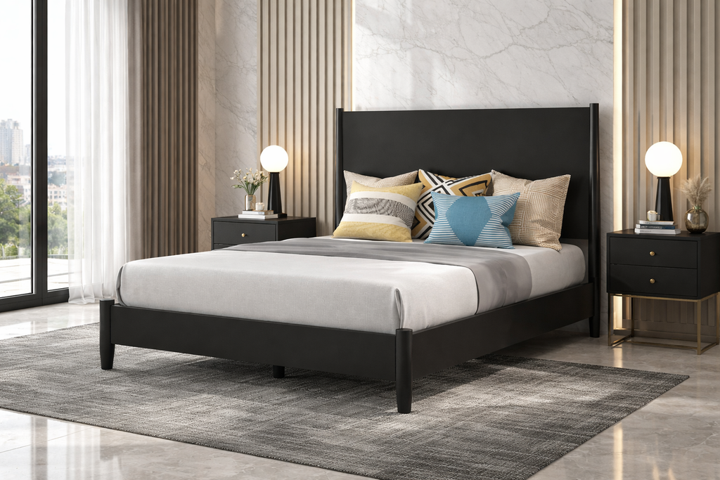 Bedroom with a black bed frame, gray bedding, and decorative pillows.