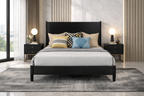 Bedroom with a black bed frame, gray bedding, and decorative pillows.